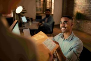 Person receiving enterprise QA services documents in office