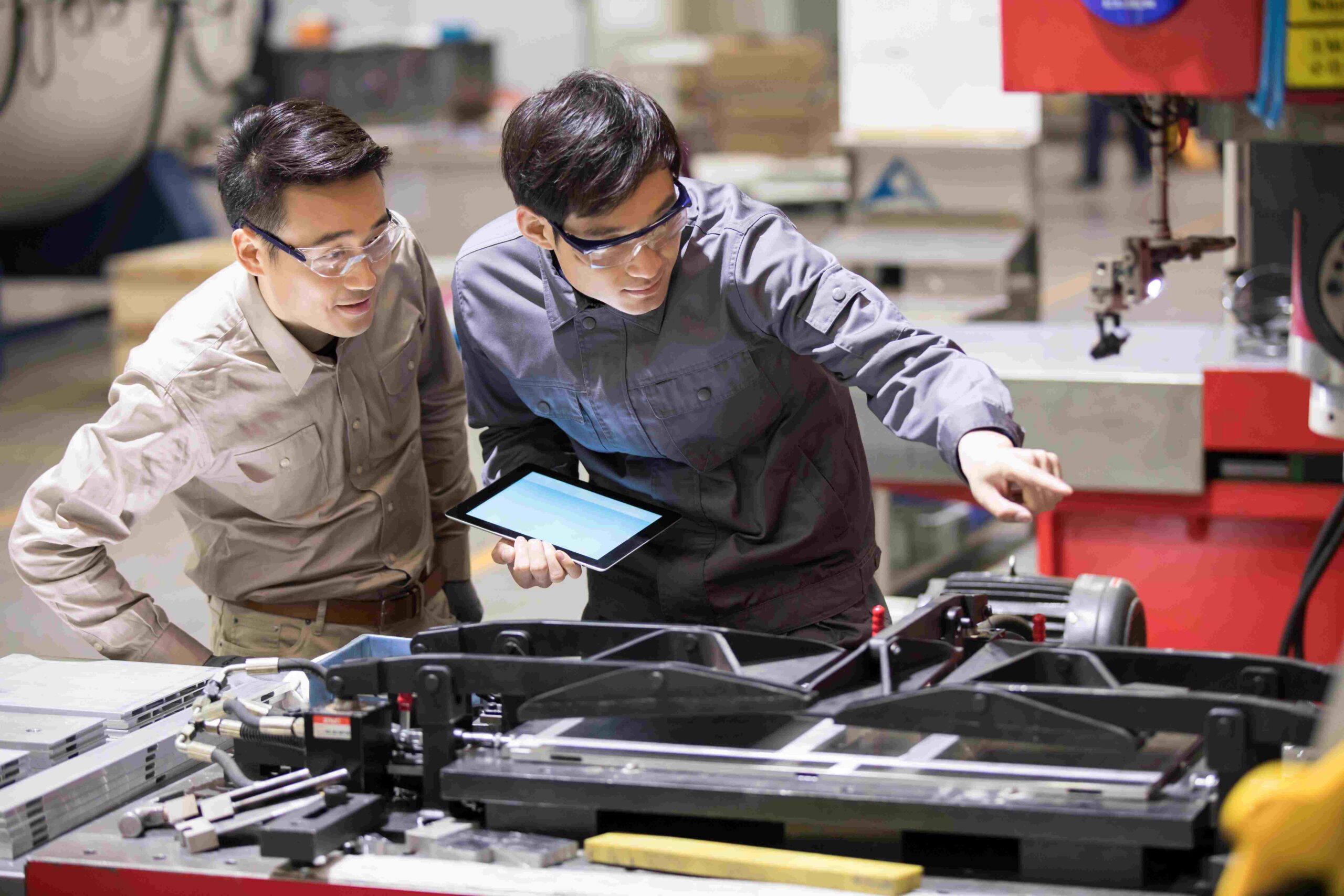 People reviewing Synthesized test data on tablet in factory