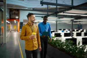 People discussing QC on Demand walking in office