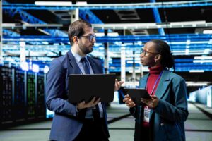 IT staff conversing with devices in high-tech server room