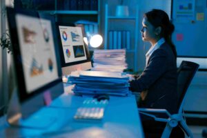 Person analyzing Synthesized reports at desk