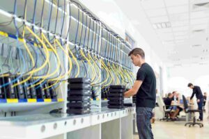 Engineer inspecting rows of equipment