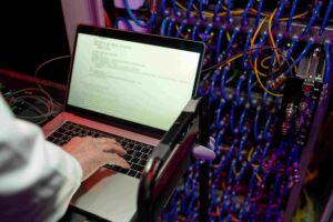 Person operating hardware test system on laptop