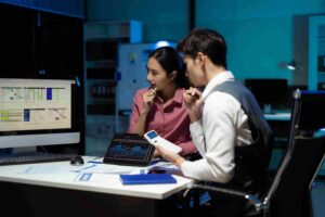 Colleagues analyzing data on tablet
