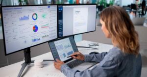 Person working on dashboard with dual monitor setup