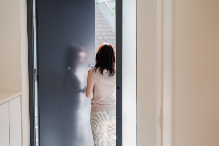 Woman using smart lock to exit house
