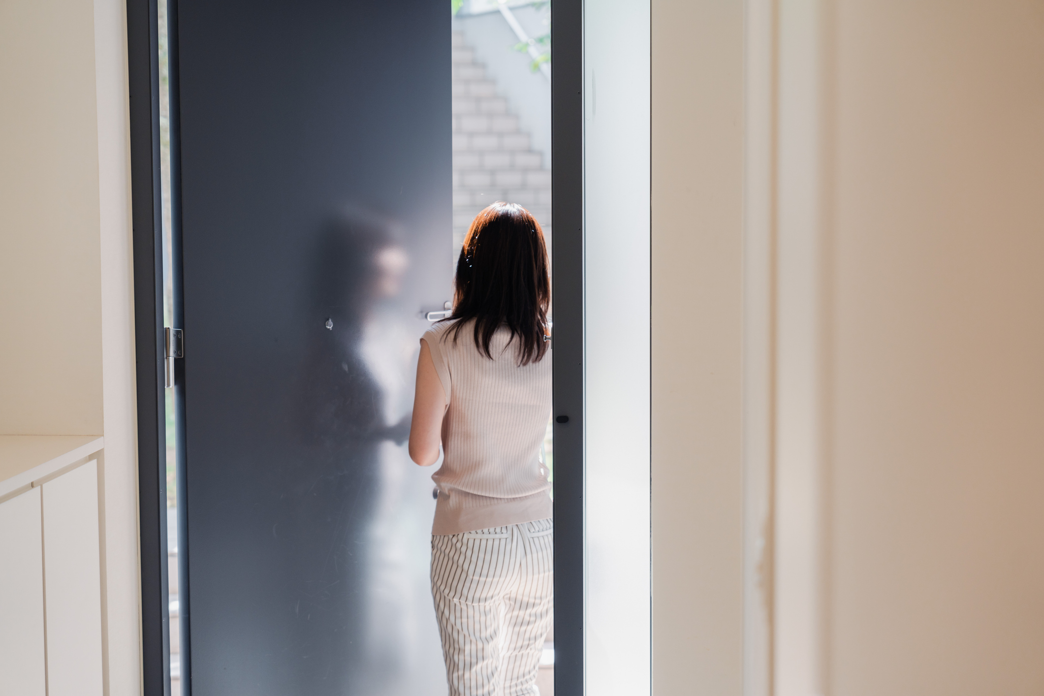 Woman using smart lock to exit house