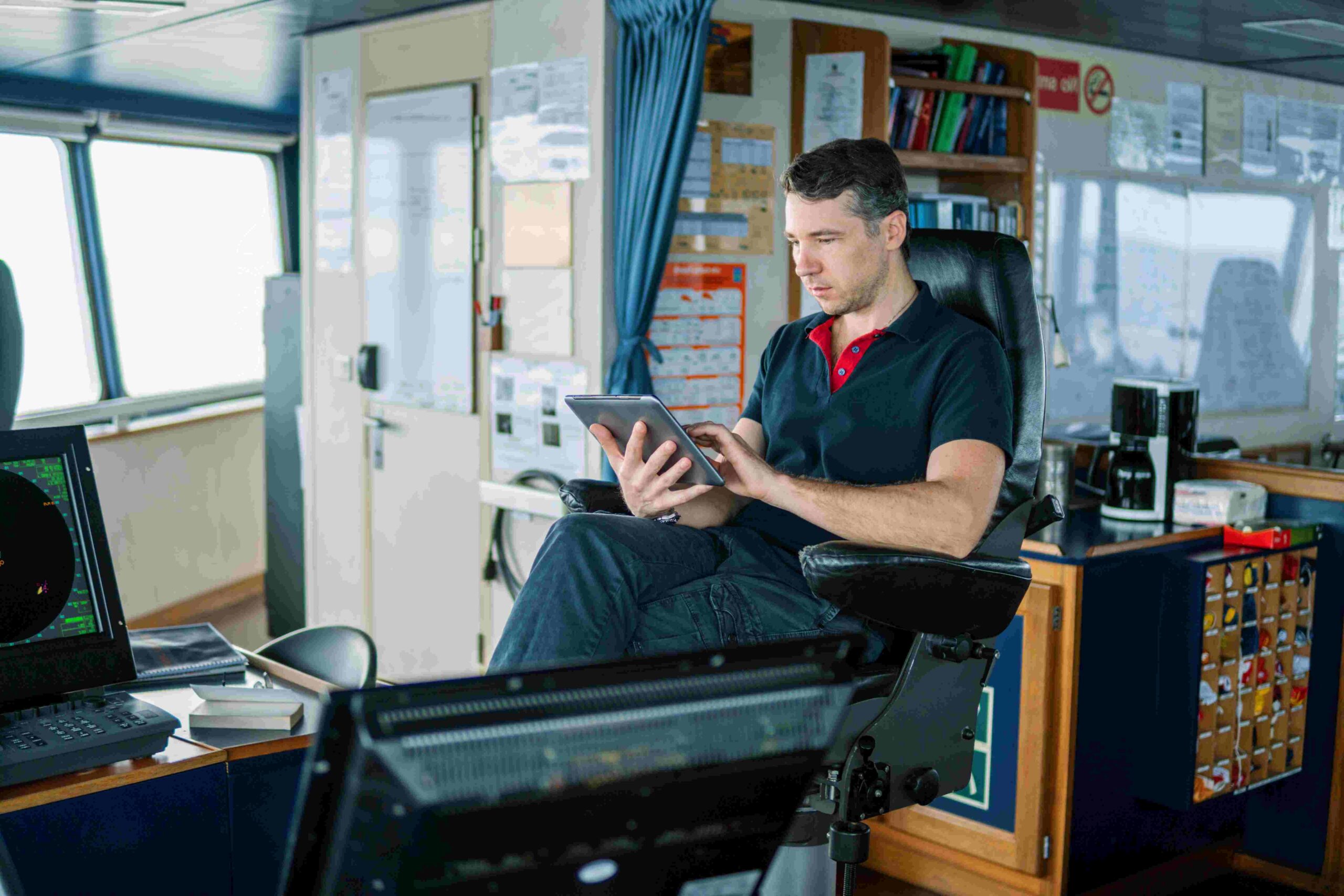 Man working on a tablet in ships cabin 2026 01 08 05 19 01 utc scaled